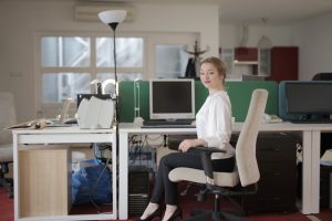 elegant-female-employee-sitting-on-chair-in-modern-workplace-3790849